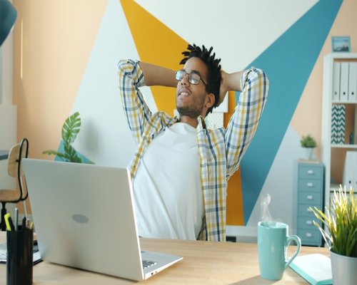 Person relaxing and looking away from screen in an office