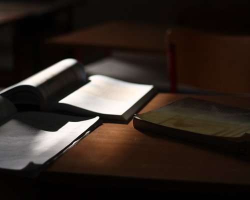 Book illuminated by soft morning light on a desk